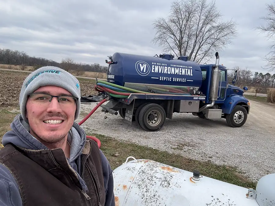 V1 Environmental company owner standing by blue truck with septic pump - Southern Illinois