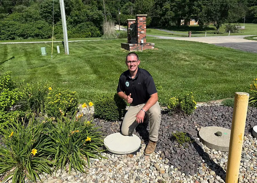 V1 Environmental company owner posing above newly installed septic system on business property - Southern Illinois