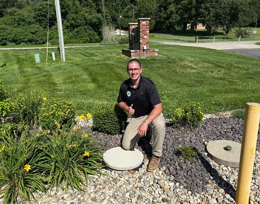 V1 Environmental company owner posing above newly installed septic system - Southern Illinois